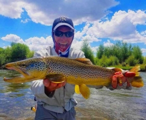 All smiles after netting this 24" brown trout